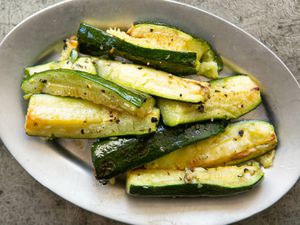 Roasted Zucchini with garlic and black pepper on a serving platter