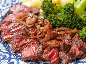 Stovetop Hanger Steak with shallots on a platter for serving