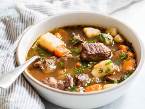Irish stew with beef, carrots, and potatoes, Guinness and wine served in a bowl