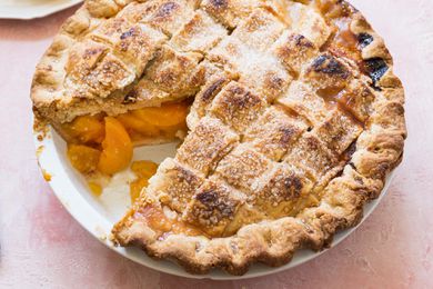 Best Peach Pie with a lattice crust and one slice removed