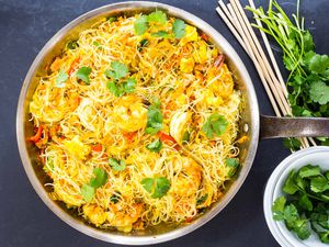 Singapore Rice Noodles Recipe with shrimp and cilantro in a skillet