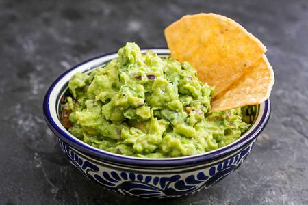 Authentic guacamole in a bowl with chips