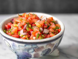 tomato salsa in a bowl showing chopped tomatoes and onion