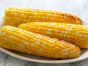 Grilled corn on the cob served on an oval platter