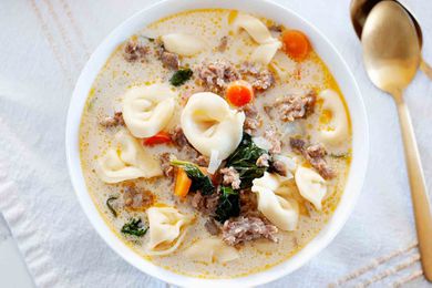 Bowl of easy homemade creamy tortellini soup with sausage, carrots, and spinach