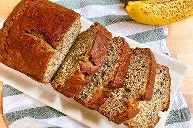 Overhead view of simple gluten-free banana bread on a platter and sliced into thick slices.