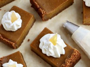 Sliced Pumpkin Pie Squares topped with whipped cream.
