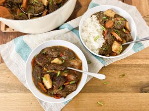 Two bowls of Jamaican Beef Stew served with rice.
