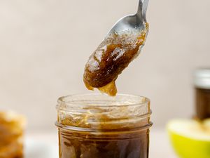 Jar of Apple Butter with Some on a Spoon