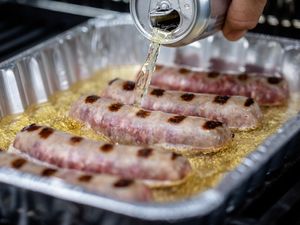 Beer Poured into Tray of Bratwurst