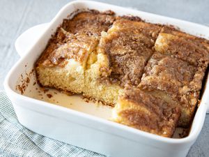 A baking pan with bisquick coffee cake and two squares removed from the pan.