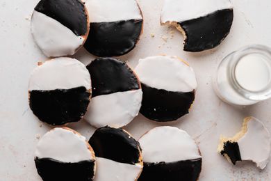 Overhead view of black and white cookies on a piece of parchment.