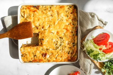 Baked burrito casserole with lettuce and tomatoes.