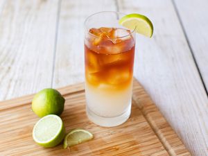 Dark and Stormy Drink on Cutting Board with Limes
