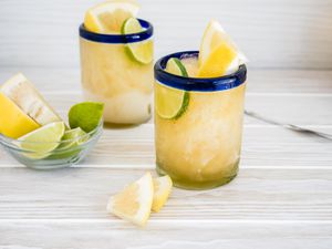 Glasses of Frozen Beer Paloma with Lime Slices and Grapefruit Wedges 