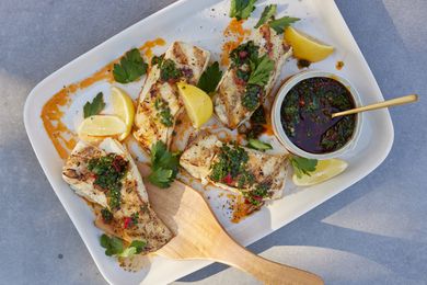 Plate of Grilled Halibut with Calabrian Chile Gremolata with Utensils on a Table