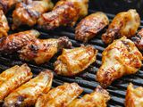 BBQ chicken wings on a grill.