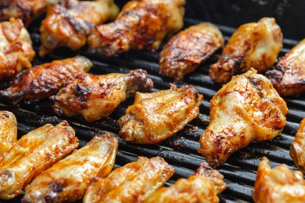 BBQ chicken wings on a grill.