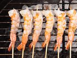 Overhead view of grilled shrimp skewers.