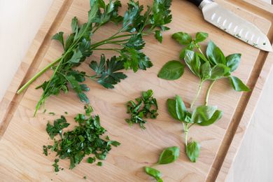 Pile of fresh herbs on a wooden cutting board