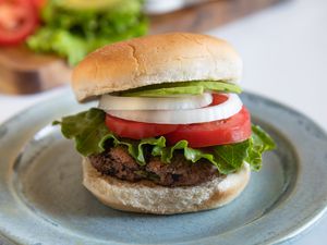 Side view of a hamburger with toppings.