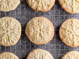 Almond-flavored butter cookies on a baking sheet.