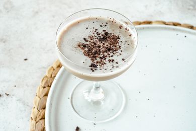 Creamy coffee cocktail on a a white platter.
