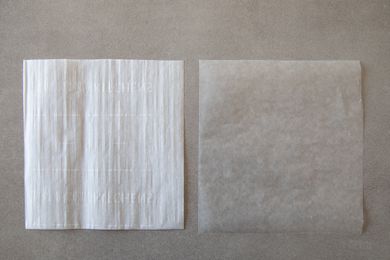 Sheet of parchment paper next to wax paper