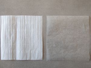 Sheet of parchment paper next to wax paper