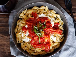 Pasta with ricotta and pan-fried tomato sauce in a bowl