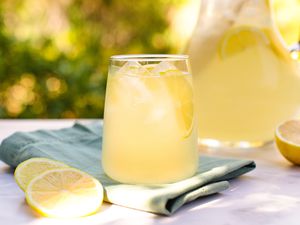 A glass and pitcher of lemonade from scratch