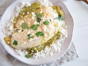 Tilapia with Salsa Verde on a plate and served with rice.