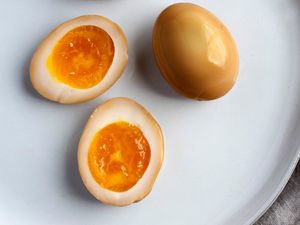 Soy Sauce Eggs on Plate with Two Eggs Cut in Half