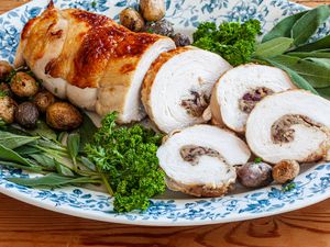 Turkey breast stuffed and sliced on a platter.