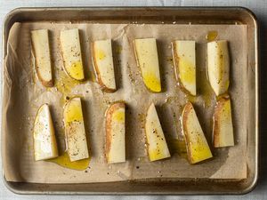 potatoes on parchment paper lined half sheet pan