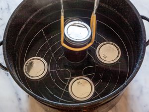 Adding Cans to Pot of Water for Bath Canning Method 