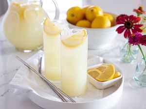 Homemade lemonade in tall glasses on a tray.