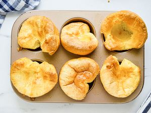 Overhead view of yorkshire puddings in a muffin tin.