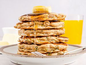 Stack of pancakes with butter and maple syrup.
